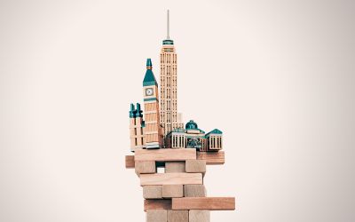 Graphic of toy buildings balanced precariously on building blocks to illustrate the article What Can the Righteous Do as the Foundations of Society Are Destroyed?